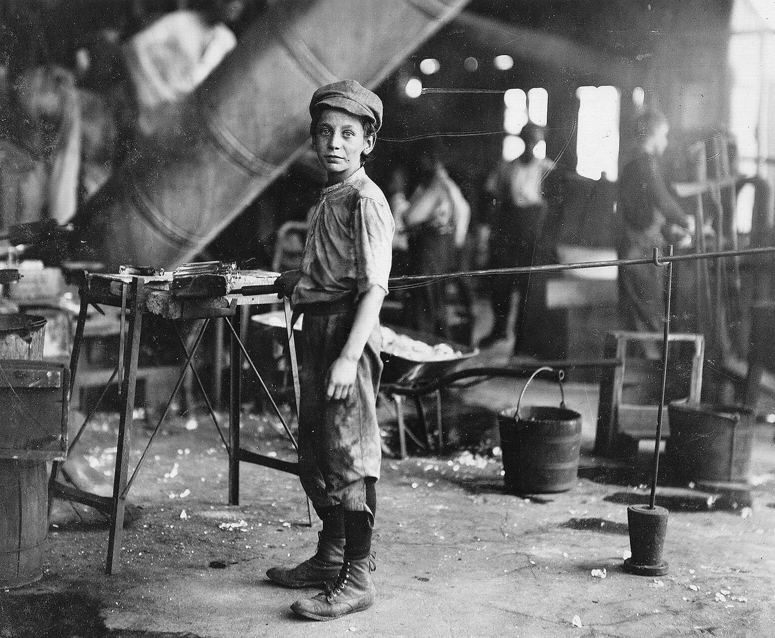 black and white photo of boy in factory